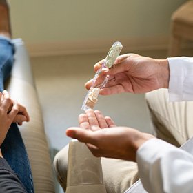 Dentist showing patient a tooth model