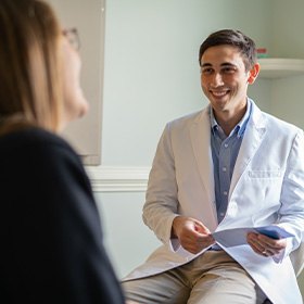 Dr. White smiling at dental patient