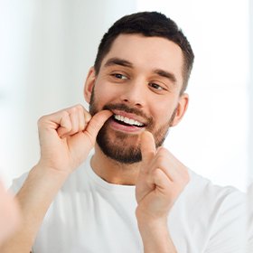 Man flossing teeth