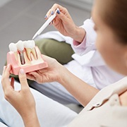 dentist showing a patient how dental implants work