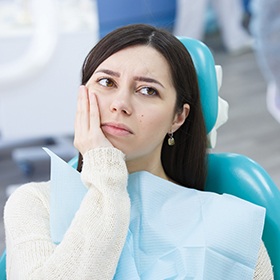 Woman holding jaw in pain