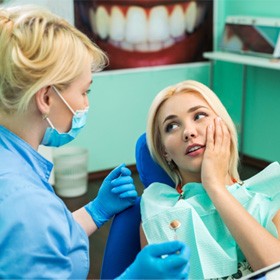 man smiling after getting dental implants in Goode