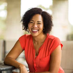 Woman smiling while sitting outside