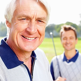 Man with implant dentures in Goode, VA on golf course