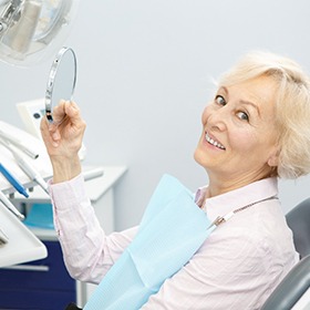 Senior female patient with implant dentures in Goode, VA