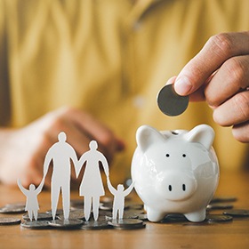 Goode patient putting money in piggy bank