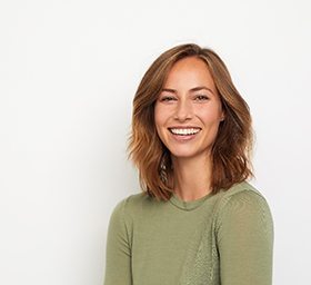 Happy woman enjoying lasting benefits of smile makeover