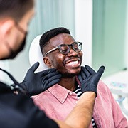 Woman smiling while flossing her teeth