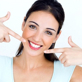 woman pointing to her white smile