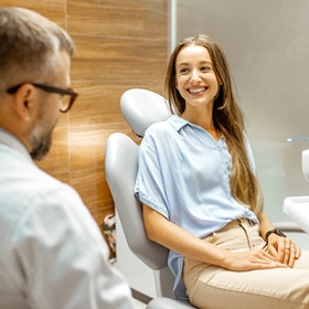 Patient smiling while talking to dentist