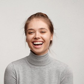 : a woman smiling after undergoing teeth whitening in Goode