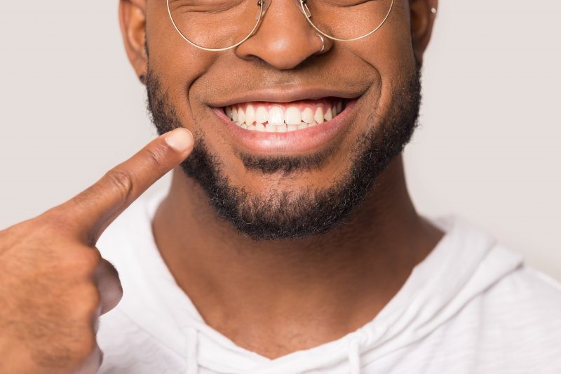 man smiling showing off white teeth