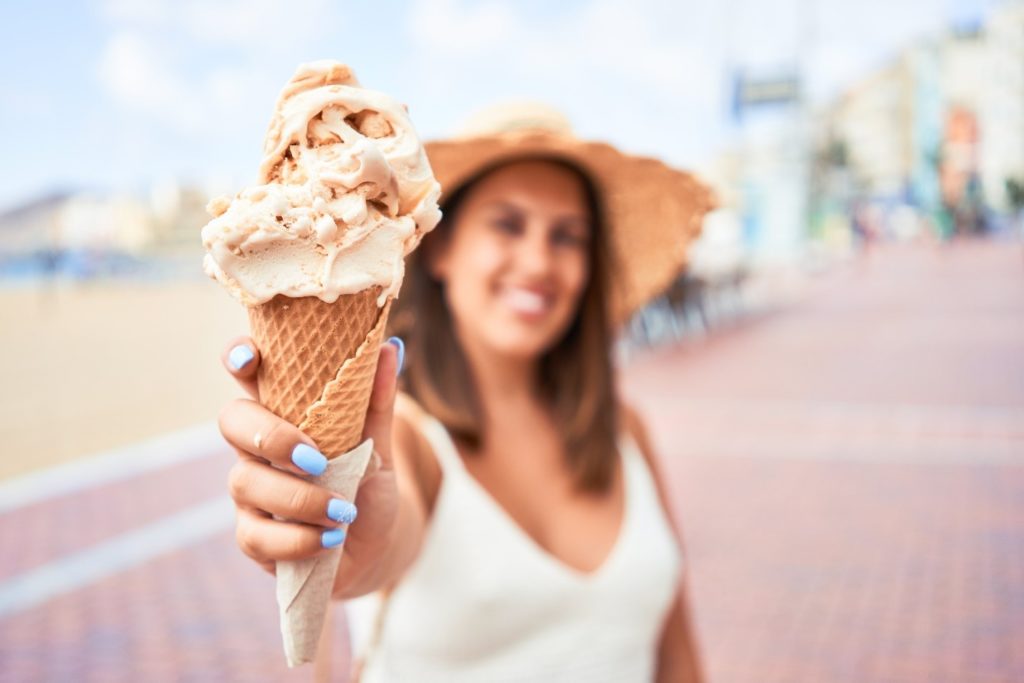 person holding out ice cream cone
